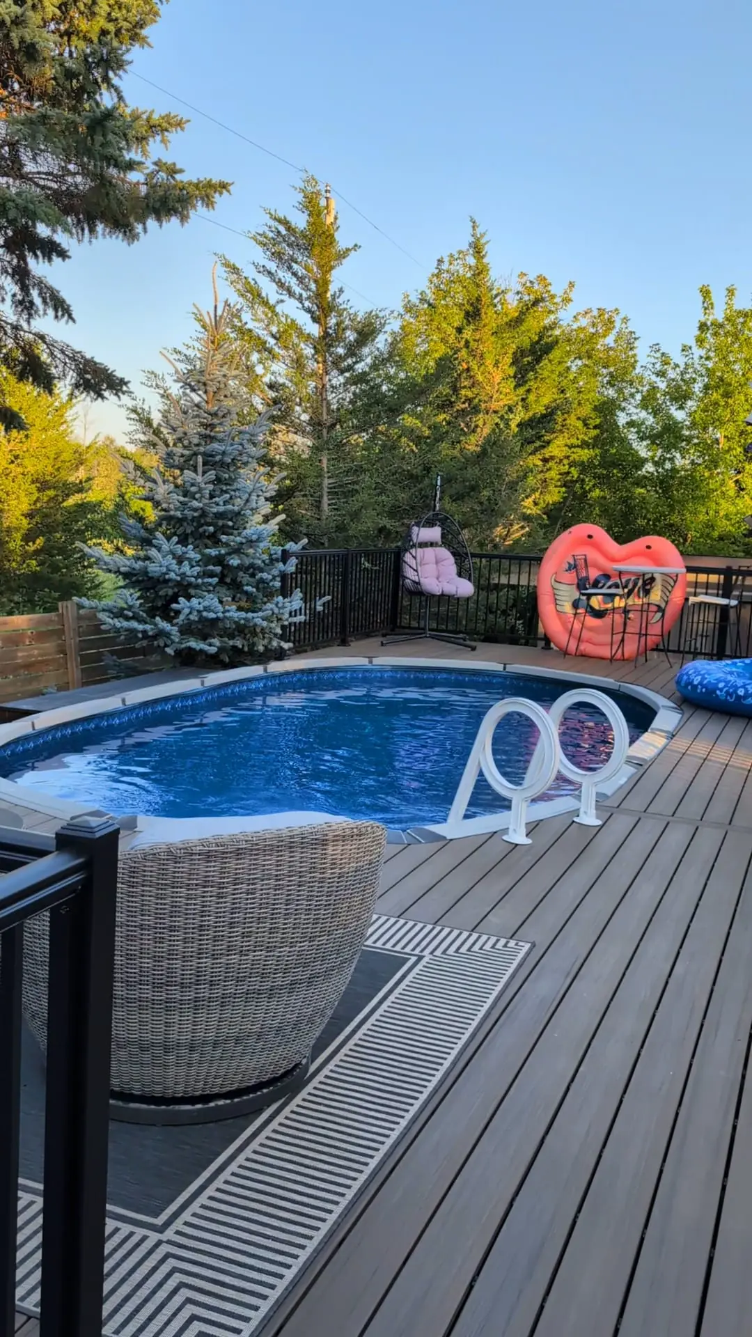 Above-ground pool surrounded by a finished composite deck